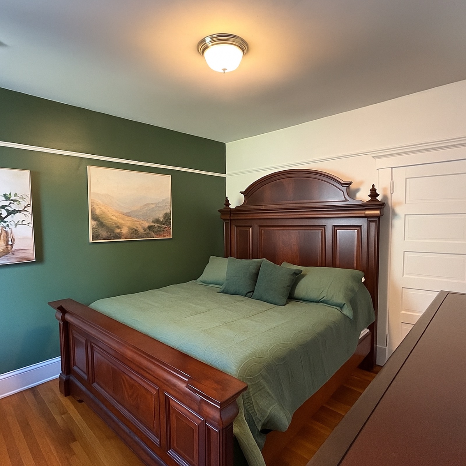 The LaCour House bedroom with green walls and sleigh bed